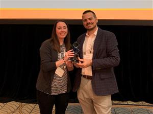 The current and former YOU director accept an award. 